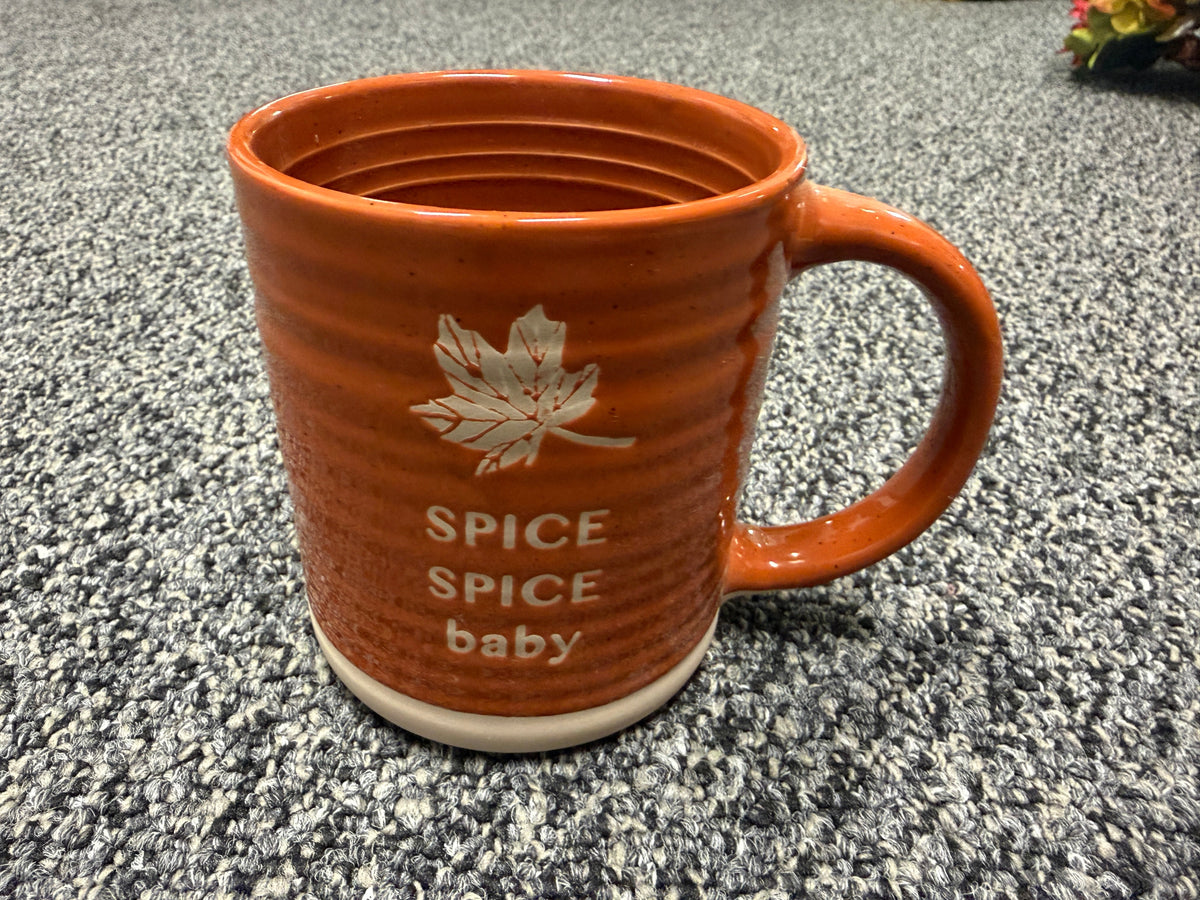 Orange stoneware mug with maple leaf and Spice Spice Baby text