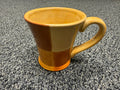 Two-tone amber and caramel stoneware mug with flared silhouette