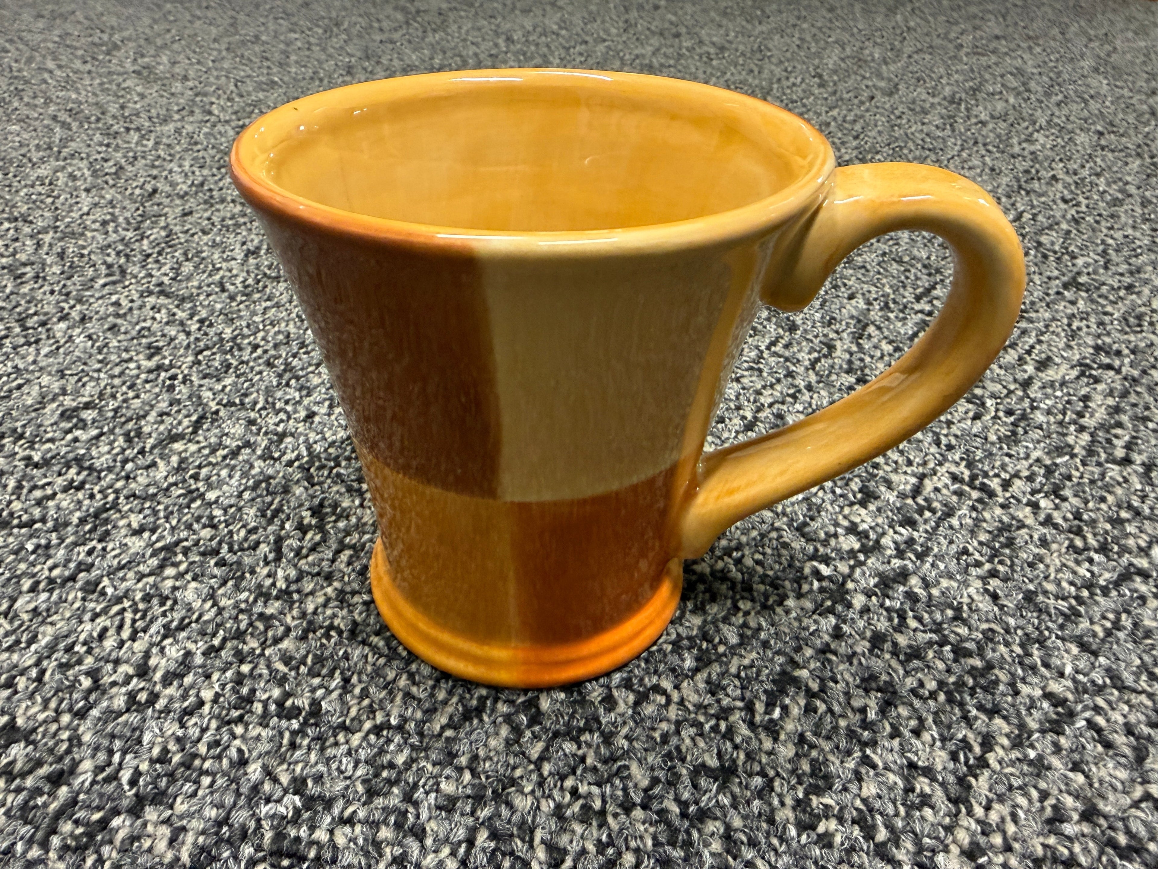 Two-tone amber and caramel stoneware mug with flared silhouette