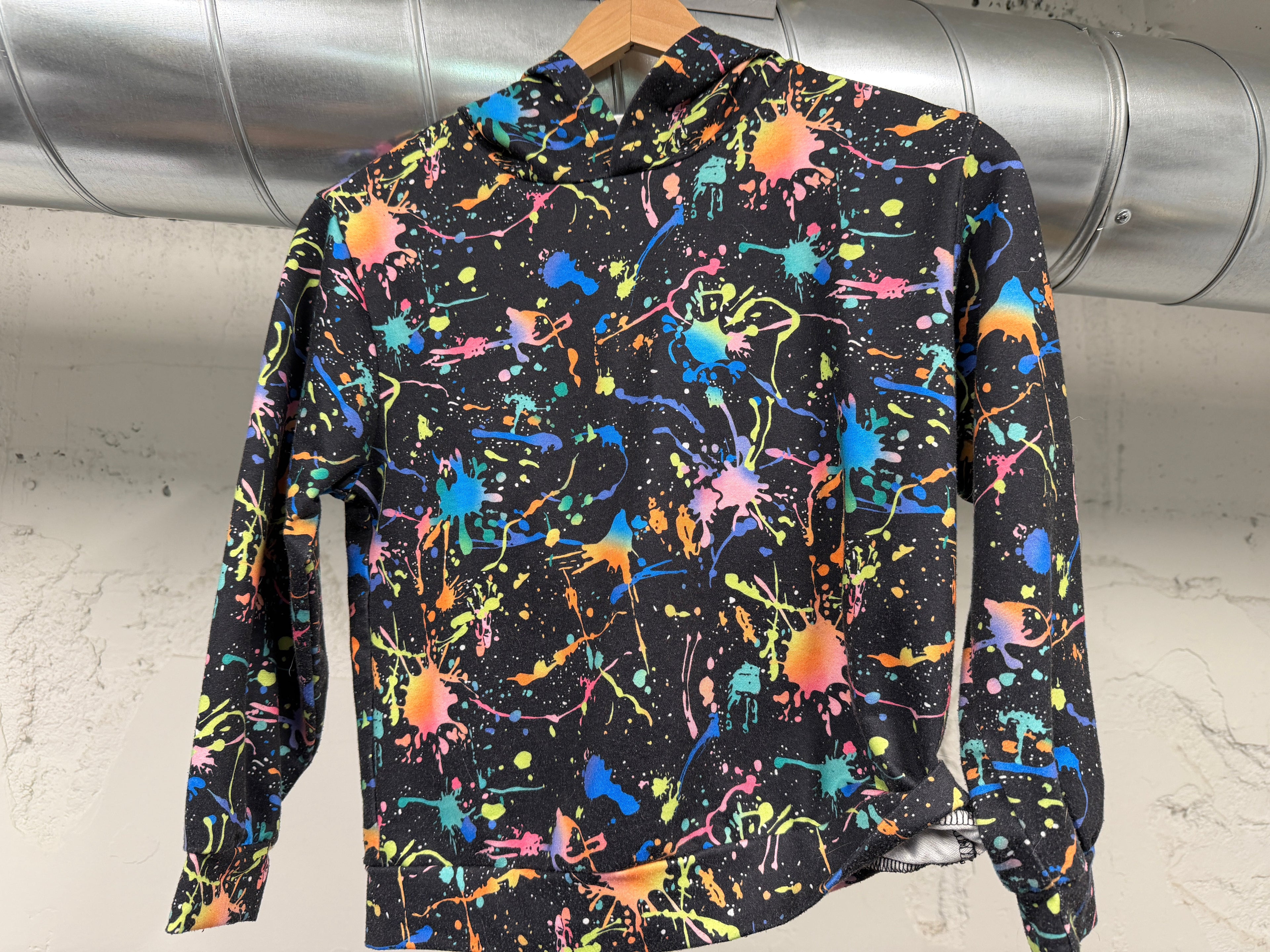 Kids black hoodie with neon paint splatter print in size 8Y