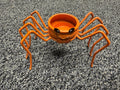 Orange glitter spider pumpkin tealight candle holder with wire legs and jack-o-lantern face