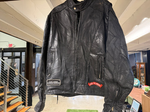 Front of vintage Live to Ride patchwork leather biker jacket with zipper pockets and patches