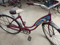 1967-1969 Schwinn Hollywood women's cruiser bicycle in original Violet finish with blue tank, chrome fenders, and Hollywood chain guard — full side profile view at The Foundry in downtown Pontiac, Michigan