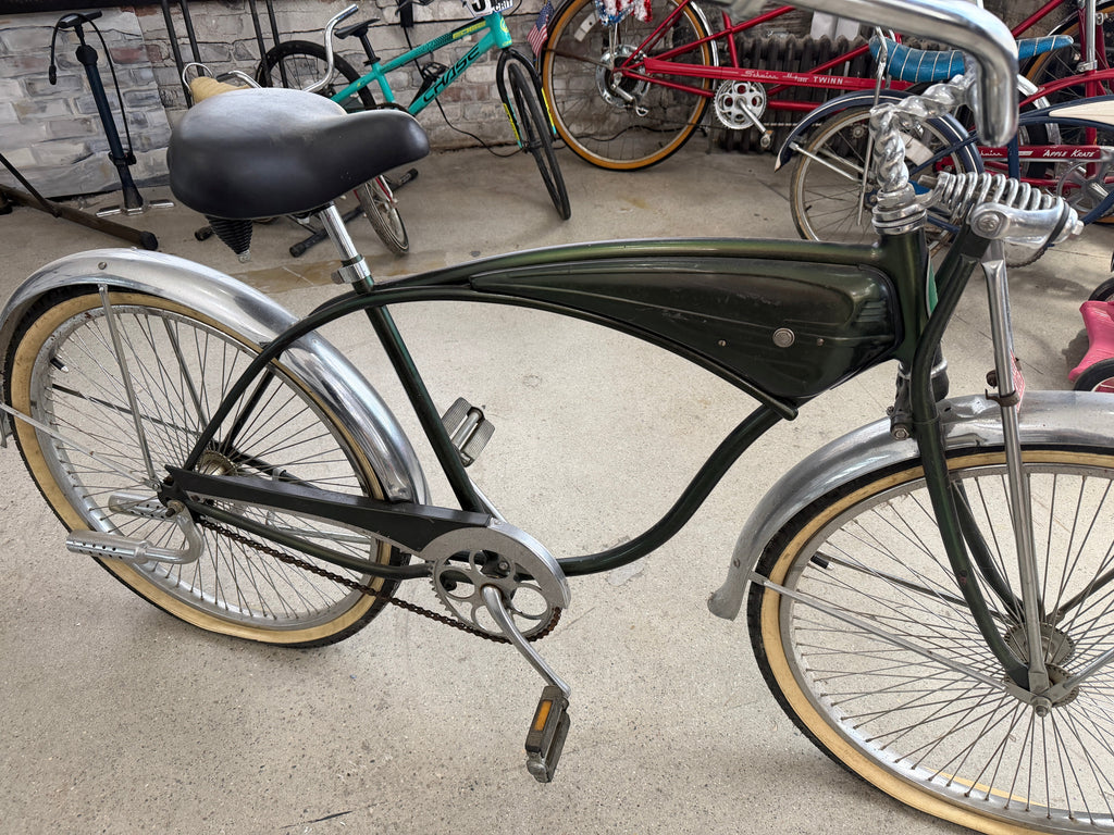 Vintage Schwinn tank cruiser full profile, forest green frame, chrome fenders, whitewall tires, springer fork