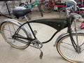 Vintage Schwinn tank cruiser full profile, forest green frame, chrome fenders, whitewall tires, springer fork