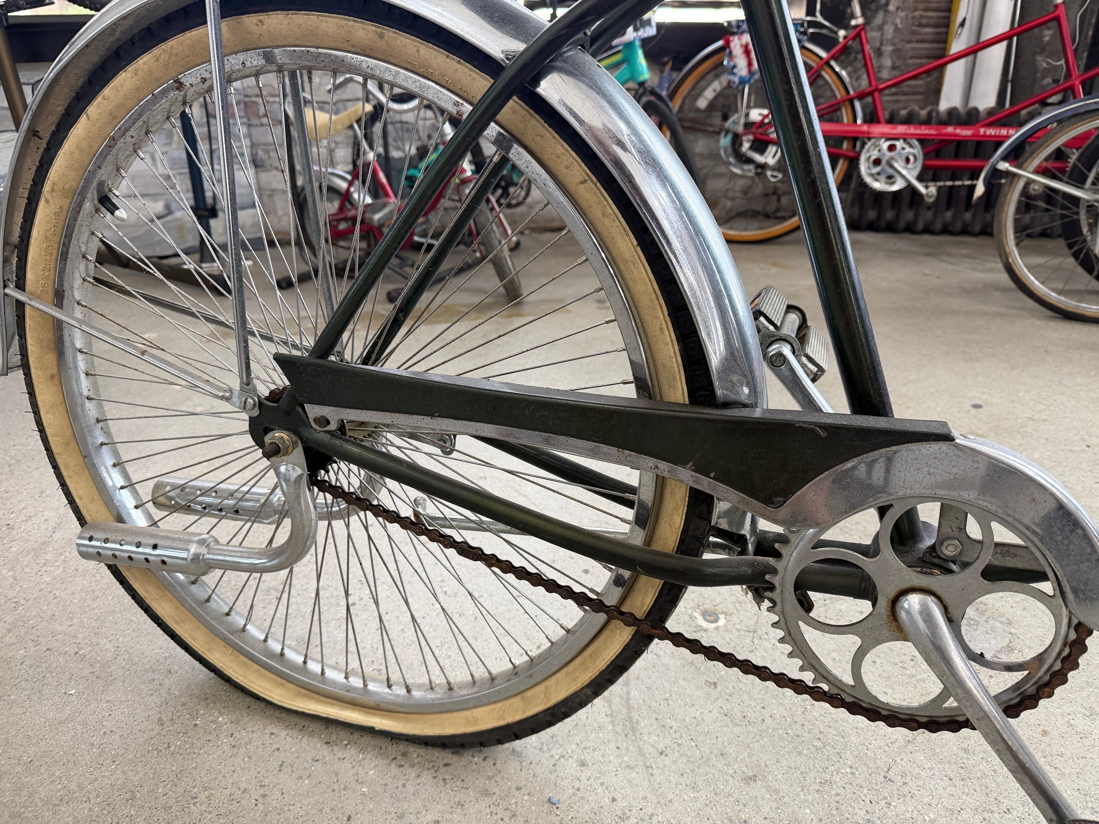 Rear wheel and drivetrain detail of vintage Schwinn tank cruiser, chrome fender and coaster brake