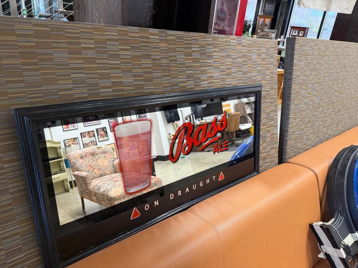Bass Ale On Draught framed beer mirror sign with red Bass Ale logo lettering, draught pint glass artwork, and black frame — pub advertising display piece at The Foundry by History Loves Company in downtown Pontiac, Michigan