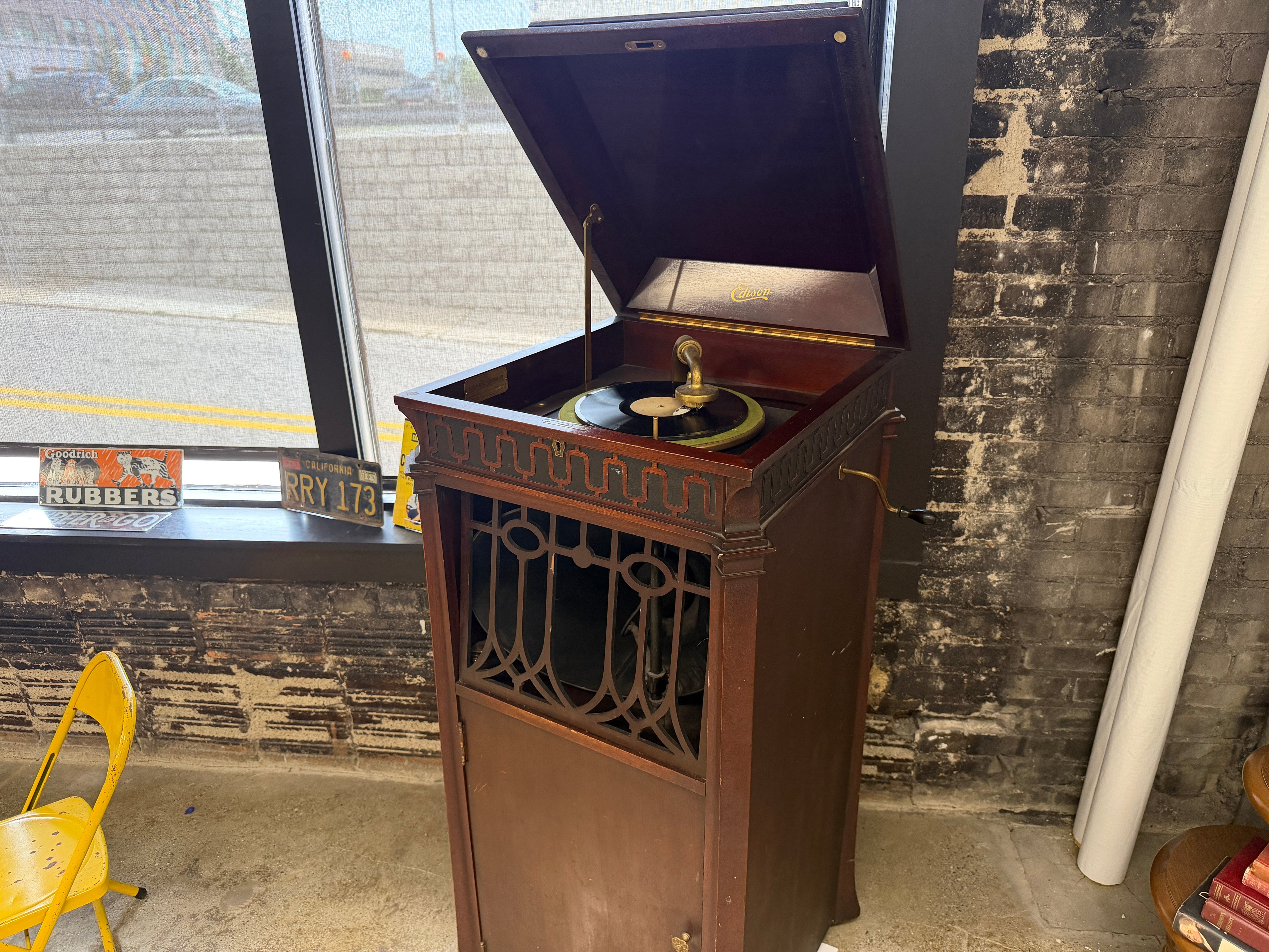 Antique Thomas A. Edison C-19 Disc Phonograph cabinet with lift-top open showing turntable, tonearm, and Edison Diamond Disc record — working antique phonograph with included records at The Foundry by History Loves Company in downtown Pontiac, Michigan