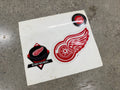 Detroit Red Wings 3-piece vintage decal set on original backing — winged wheel die-cut, hockey puck diamond logo, Western Conference Central Division seal