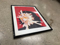 Framed Che Guevara milk splash pop art print, bold red background with black silhouette and white liquid explosion, black frame white mat