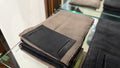 The Forge Hip Pack in brown woven canvas with black front pocket, Pontiac Built by The Foundry, displayed on glass shelf