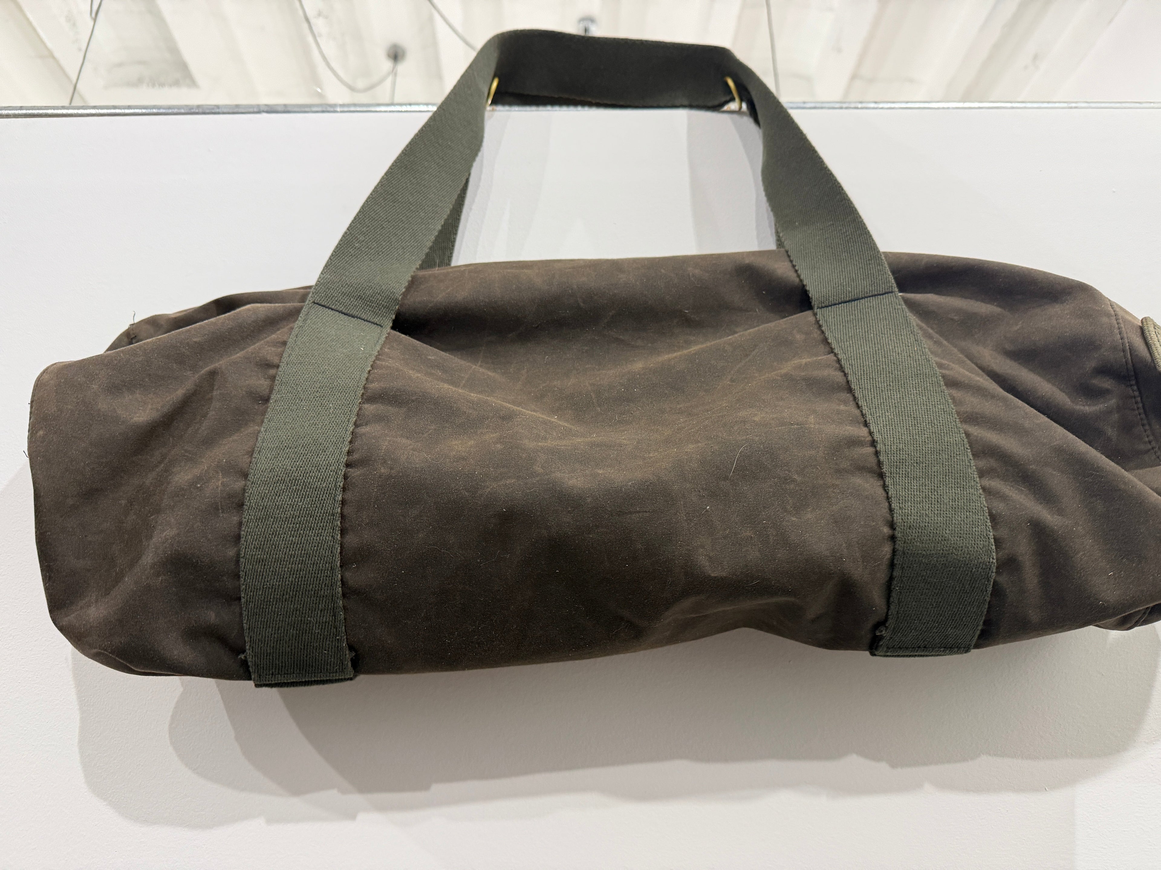 The Weekender Duffle in dark olive by The Foundry, made in Pontiac Michigan, top carry handles with brass hardware