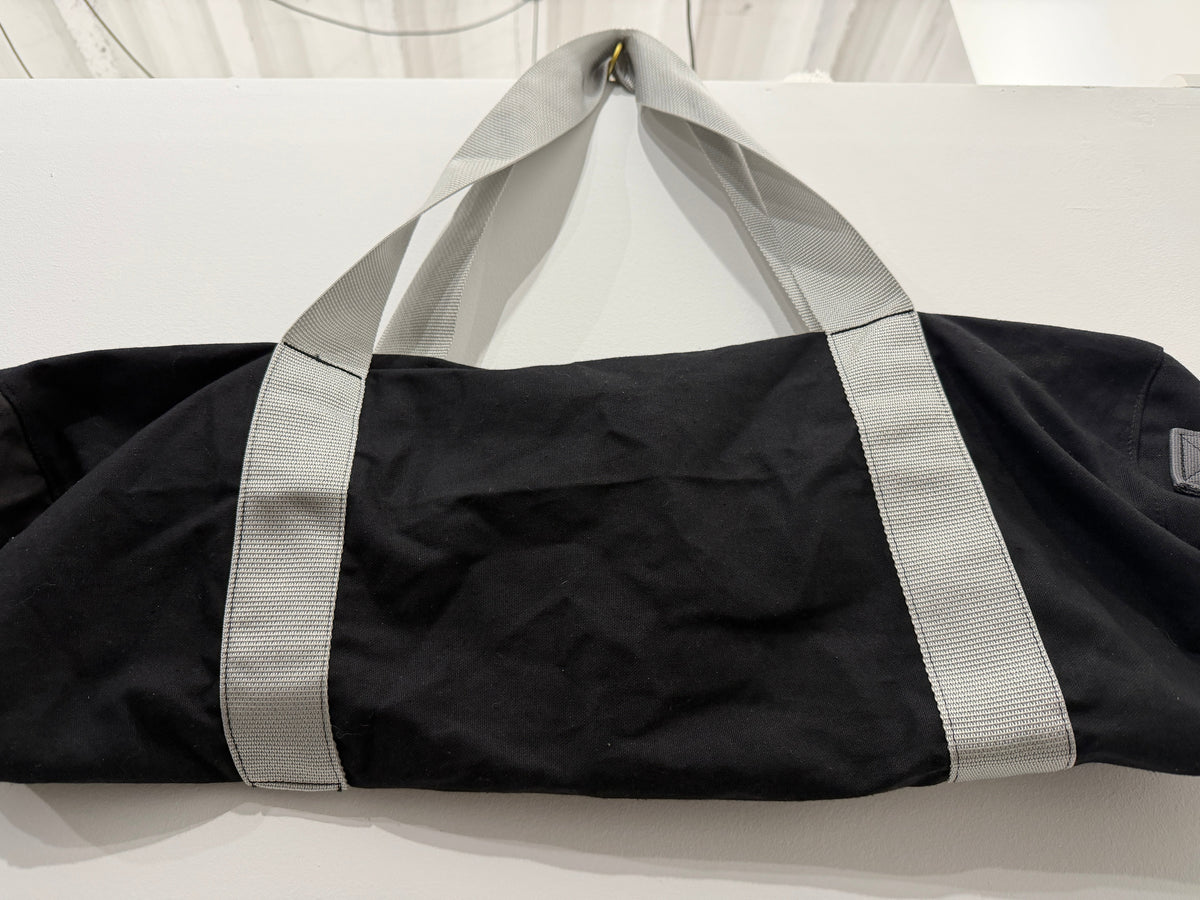 The Weekender Duffle in black with grey straps by The Foundry, made in Pontiac Michigan