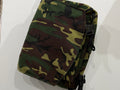 The Crosstown Sling Bag in woodland camo canvas with black buckle hardware and adjustable webbing strap, Pontiac Built by The Foundry
