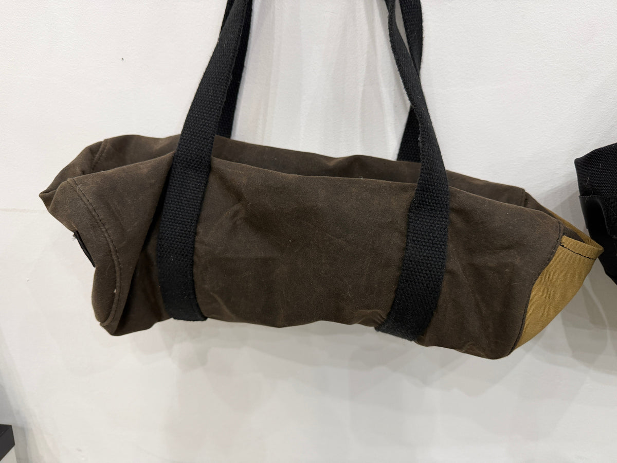 The Day Trip Duffle in olive waxed canvas with tan end panels and black straps, Pontiac Built by The Foundry