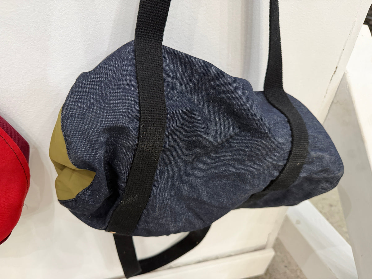 The Day Trip Duffle in navy canvas with tan end panels and black straps, Pontiac Built by The Foundry