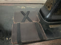 The Switch Wallet elastic band style — dark chocolate leather with black elastic X-cross and horizontal band, two wallets stacked, Pontiac Built