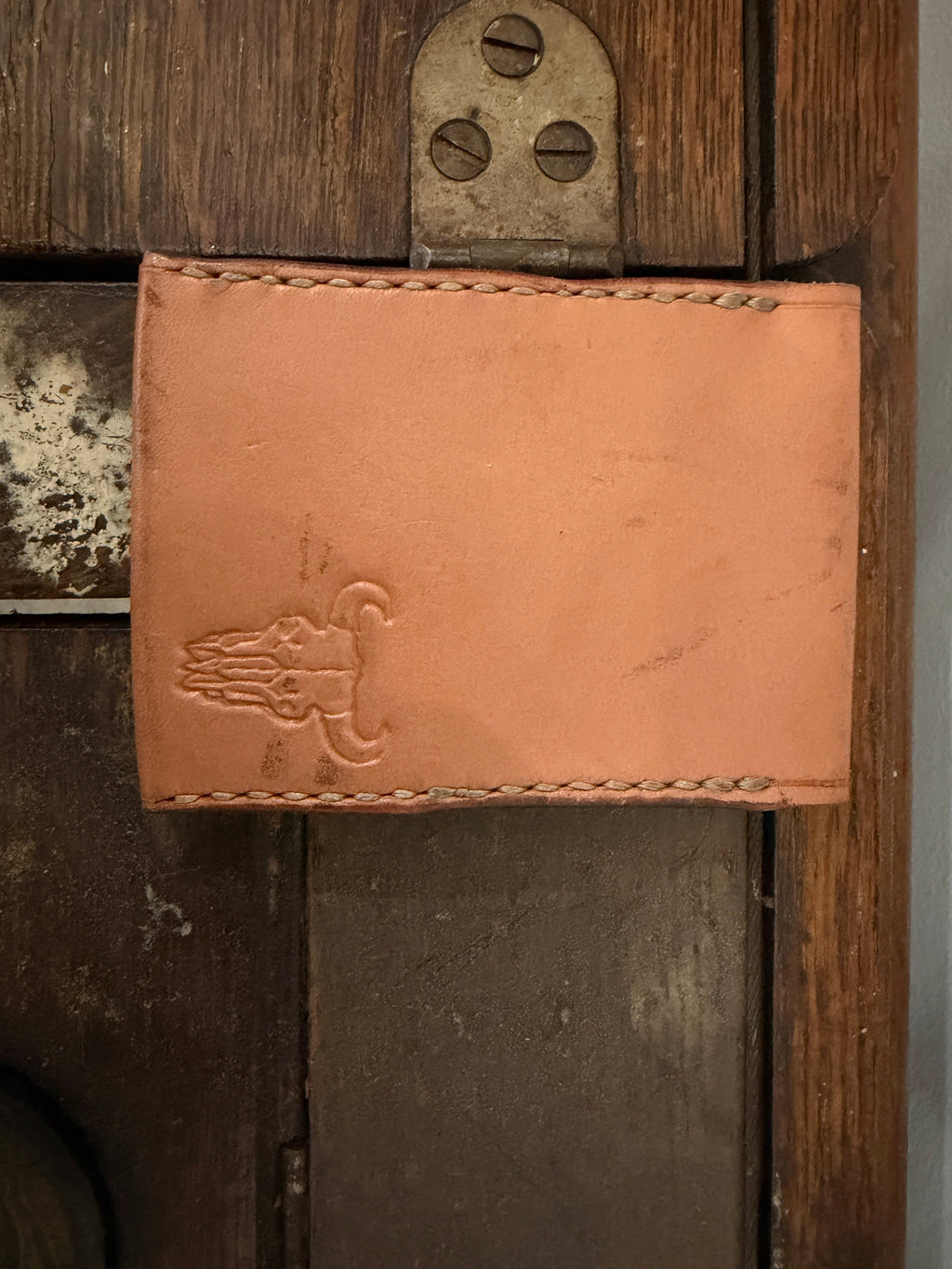 The Forge Billfold in natural tan full-grain leather with hand-stamped Foundry maker mark and cream saddle stitch, Pontiac Built