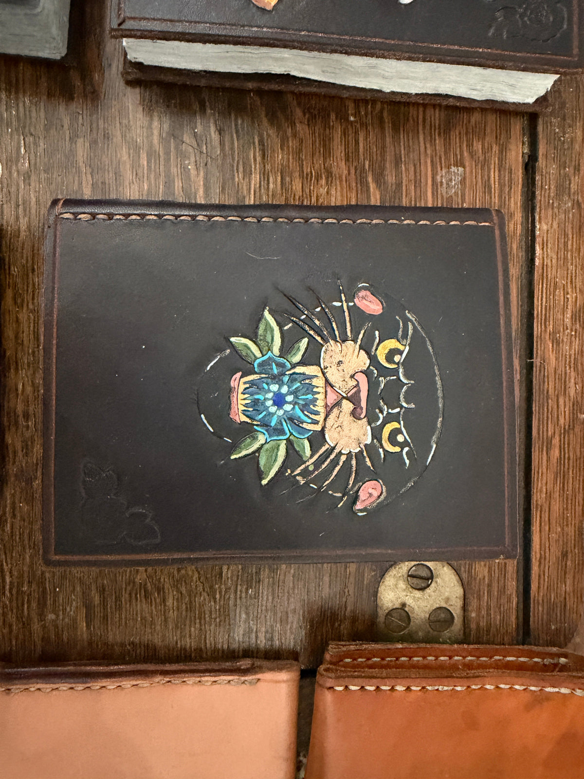 Handmade leather journal with hand-painted floral and moon phase design on dark leather cover, recycled card paper pages, Pontiac Built