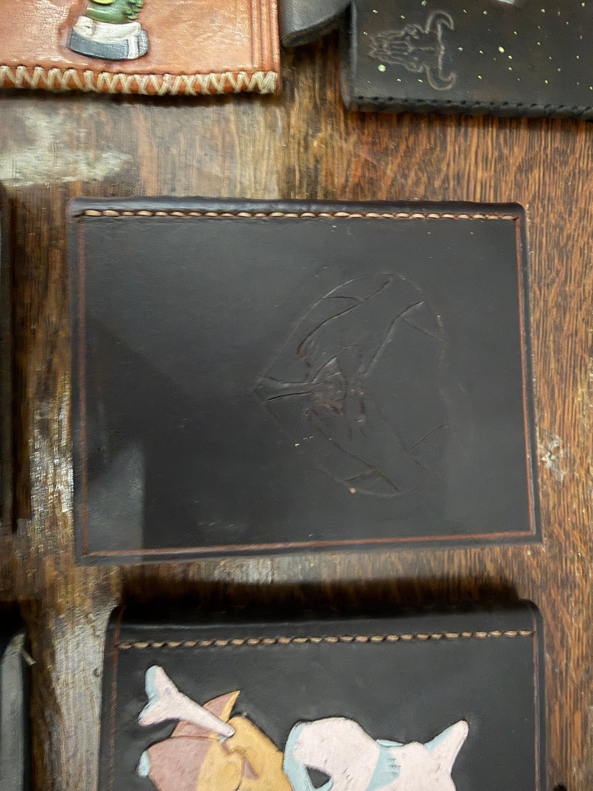Handmade leather journal with hand-tooled bird in flight design on dark leather cover, recycled card paper pages, Pontiac Built
