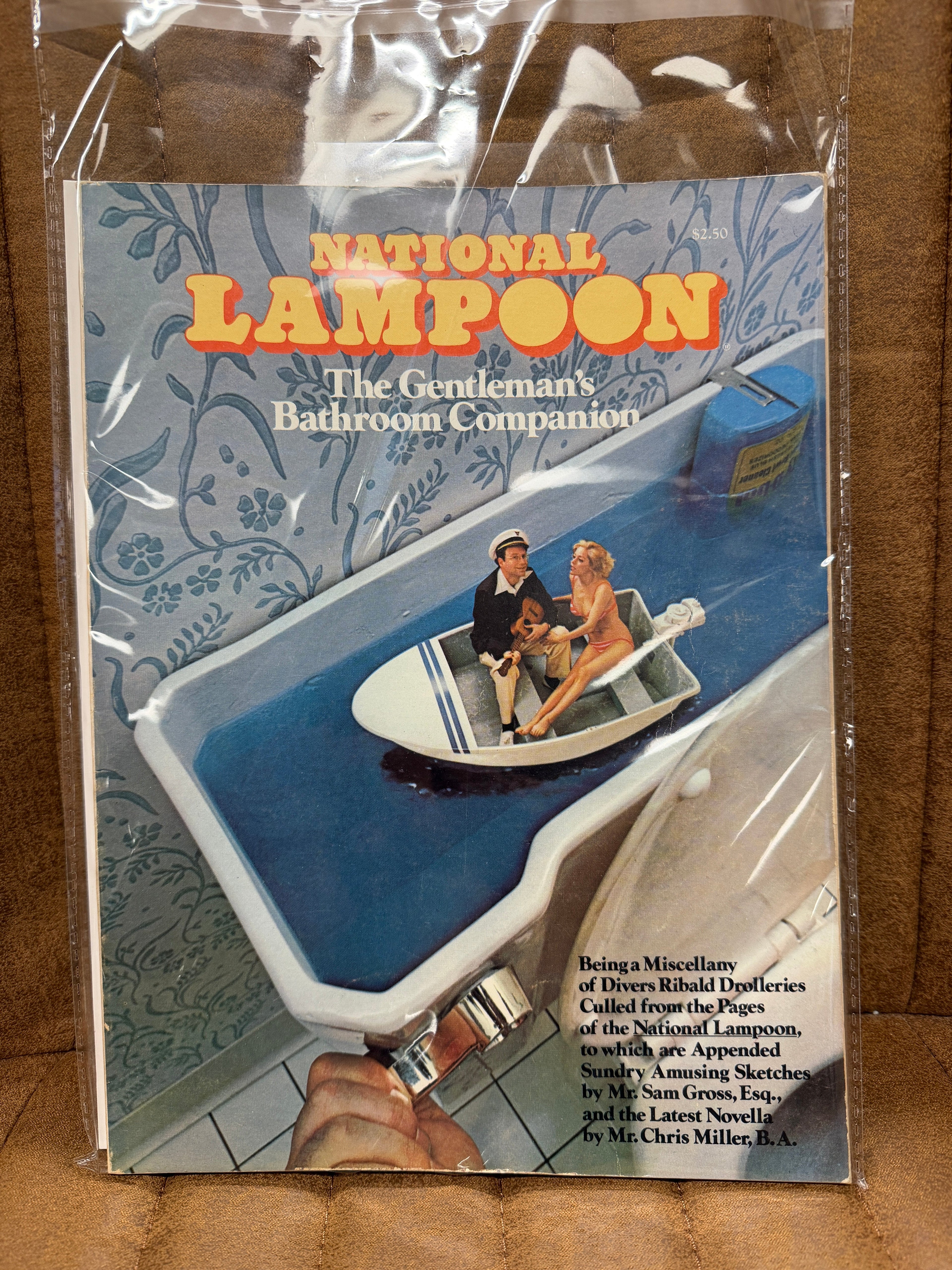 National Lampoon The Gentleman's Bathroom Companion sealed in original poly bag, cover showing man and woman in motorboat in bathtub, cover price $2.50