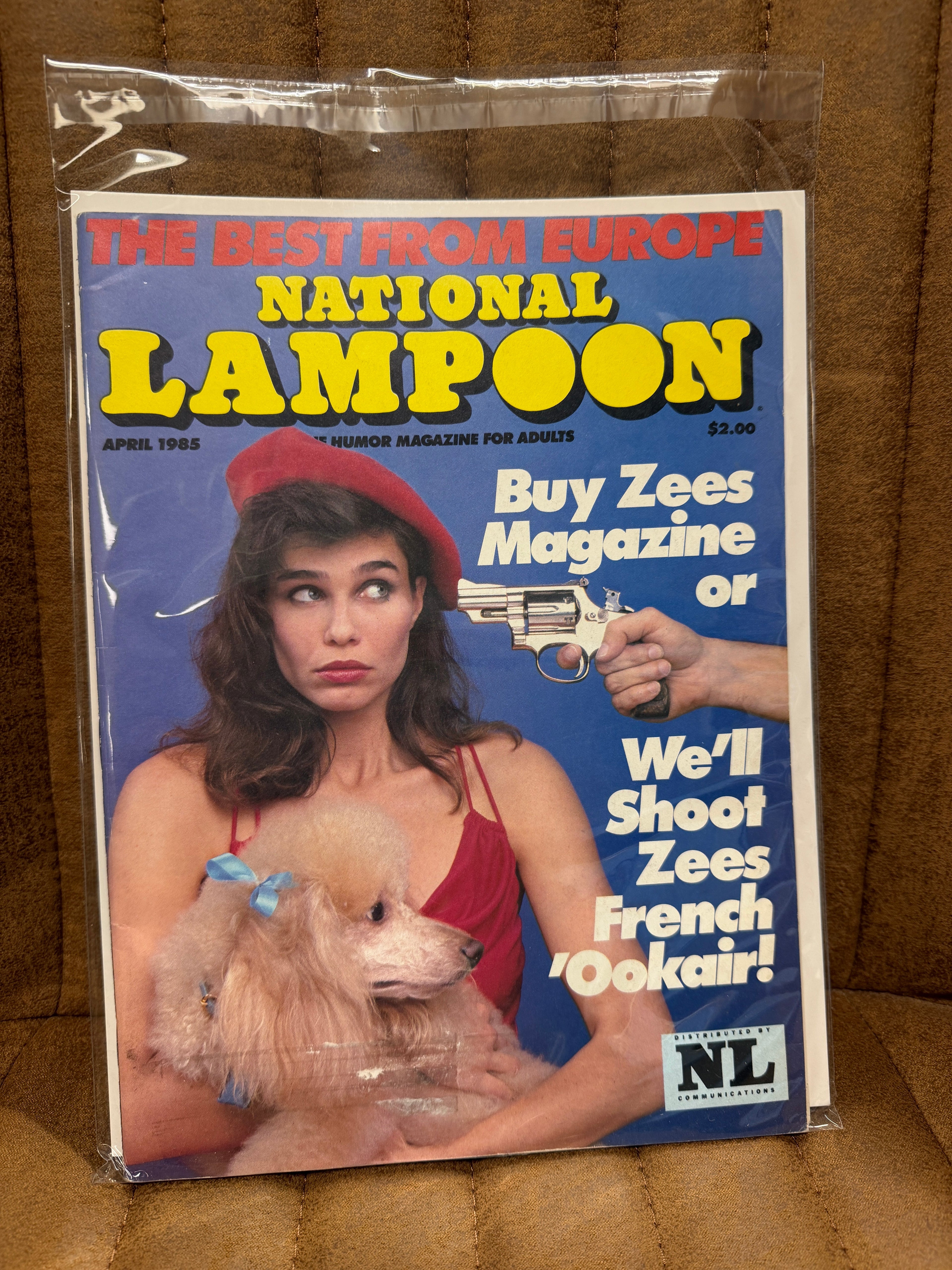 National Lampoon April 1985 The Best from Europe sealed in original poly bag, French poodle cover with Buy Zees Magazine or We'll Shoot Zees French Ookair, cover price $2.00