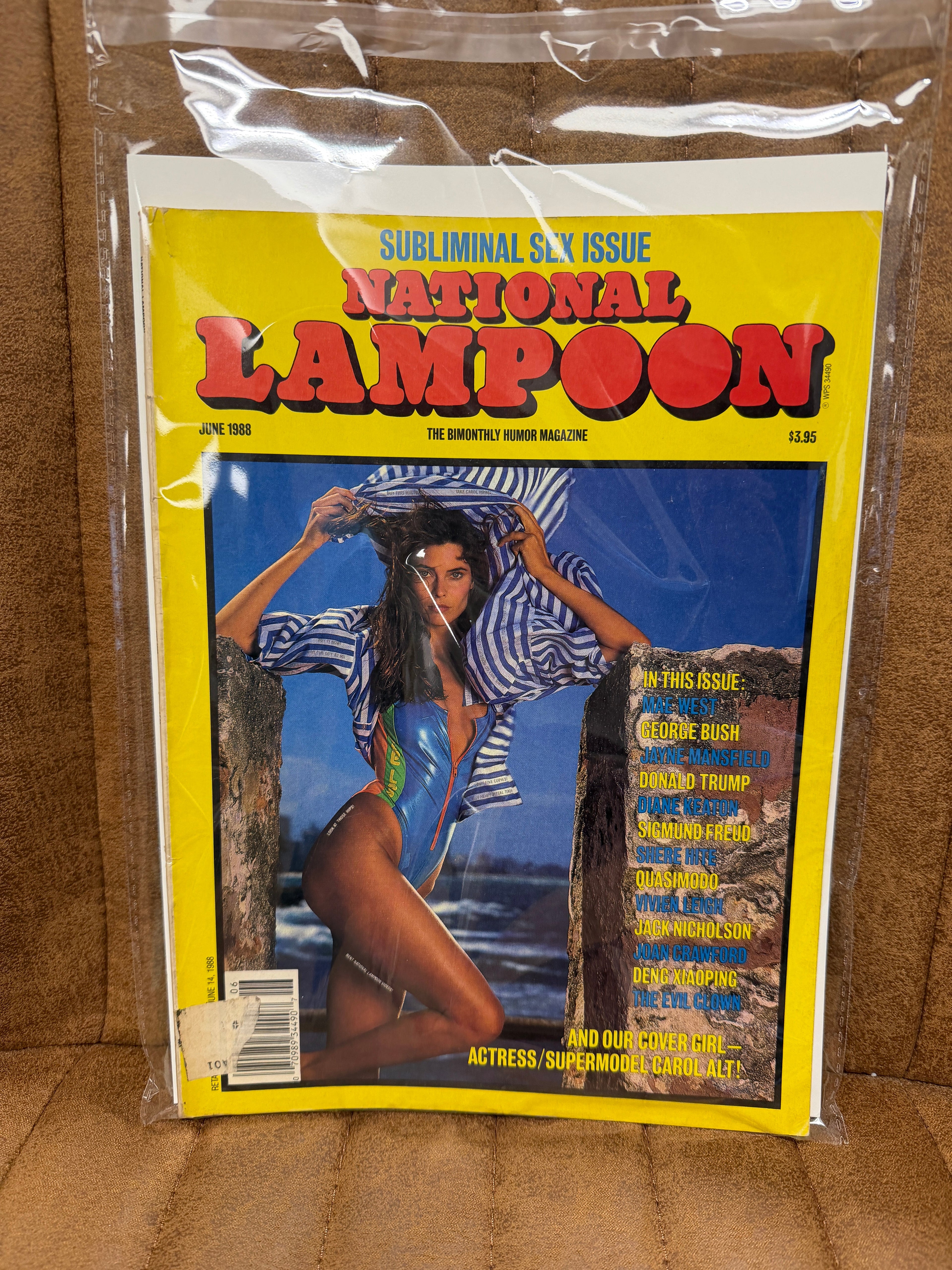National Lampoon June 1988 Subliminal Sex Issue sealed in original poly bag, Carol Alt cover in blue swimsuit on beach, yellow background, cover price $3.95