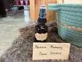 Rescue Remedy Flower Essence by Everly Rose in amber glass spray bottle with handmade label, displayed on fur with teal basket