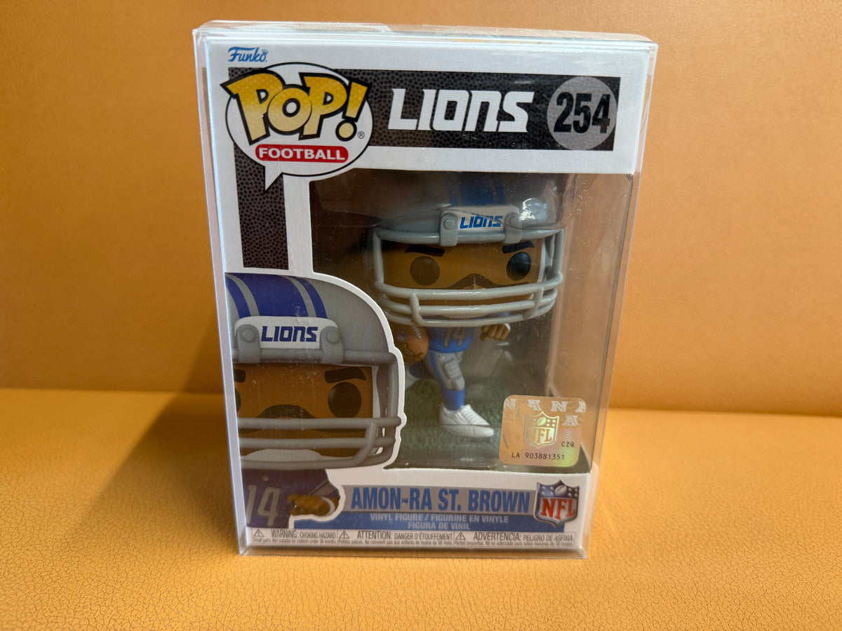 Funko Pop Amon-Ra St. Brown #254 Detroit Lions NFL Football in box with acrylic protector case