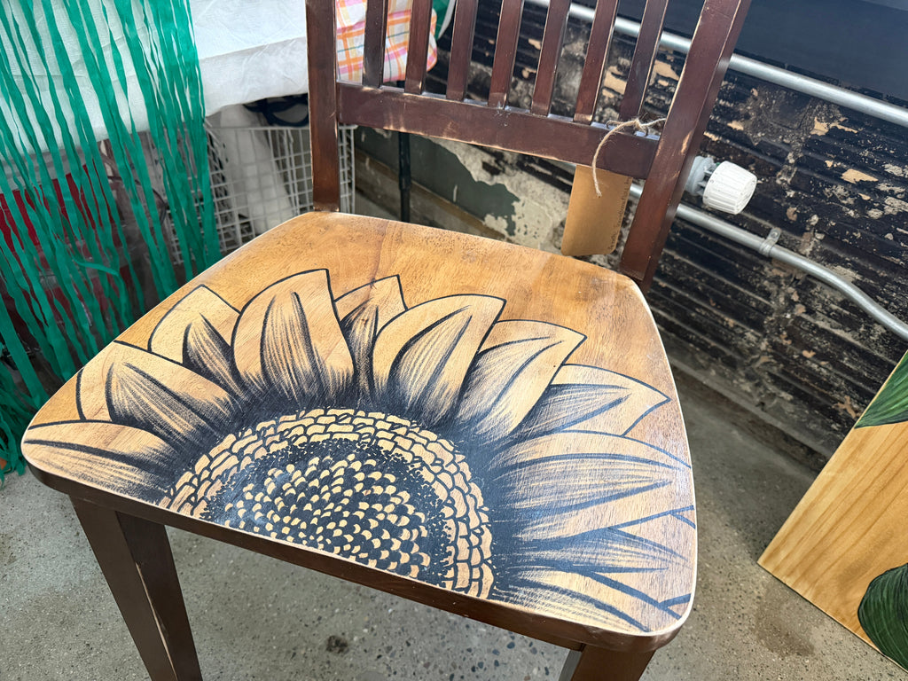 Distressed vintage wood chair with large hand-drawn sunflower covering the seat by Renee Reese