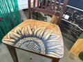Distressed vintage wood chair with large hand-drawn sunflower covering the seat by Renee Reese