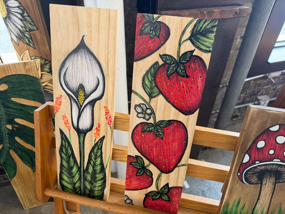 Hand-drawn strawberries with green leaves and white blossom on natural wood panel by Renee Reese