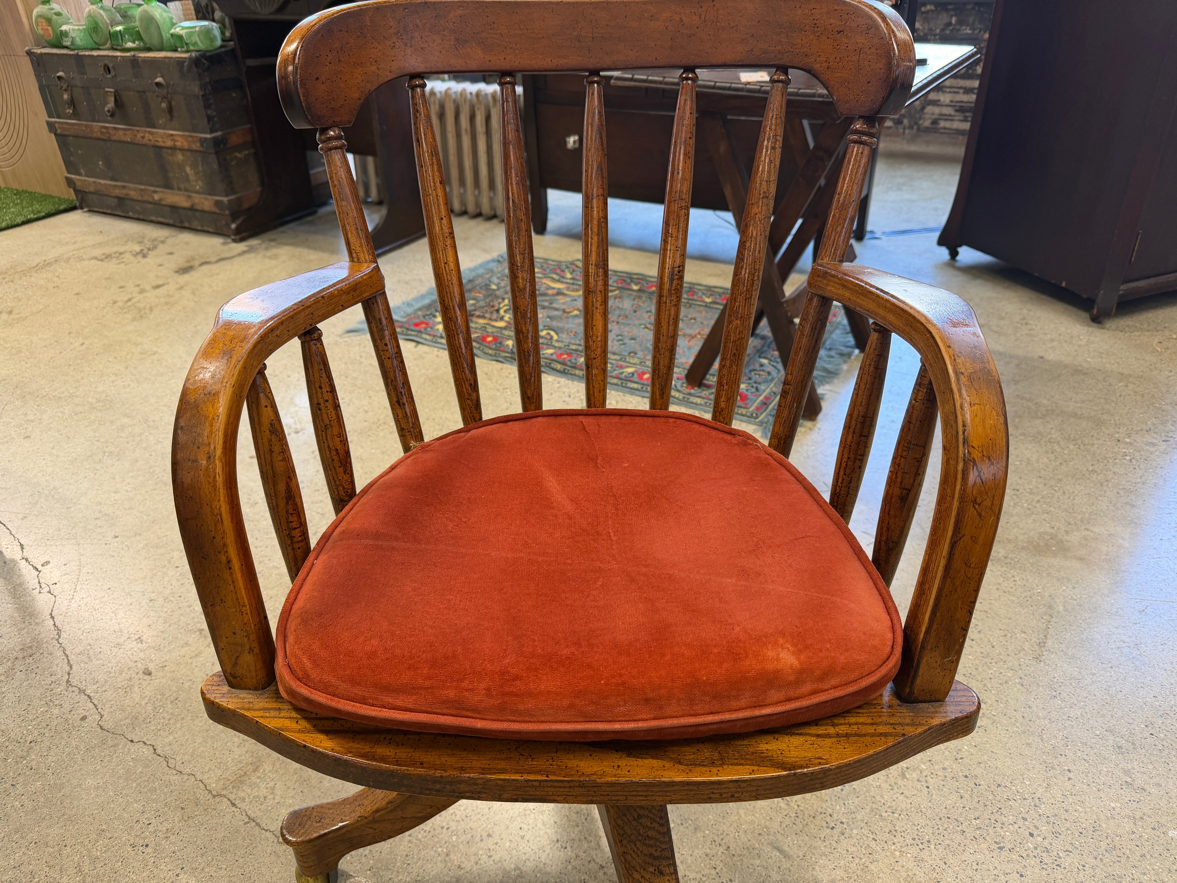 Antique oak banker swivel chair with rust upholstered seat, front view