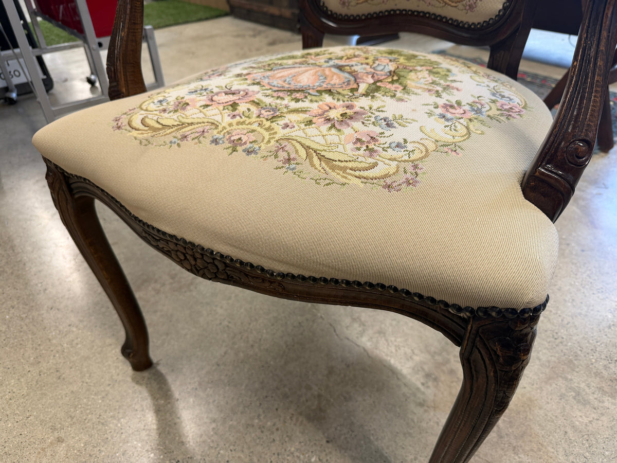 Detail of carved walnut cabriole leg and needlepoint seat with floral and figural motifs