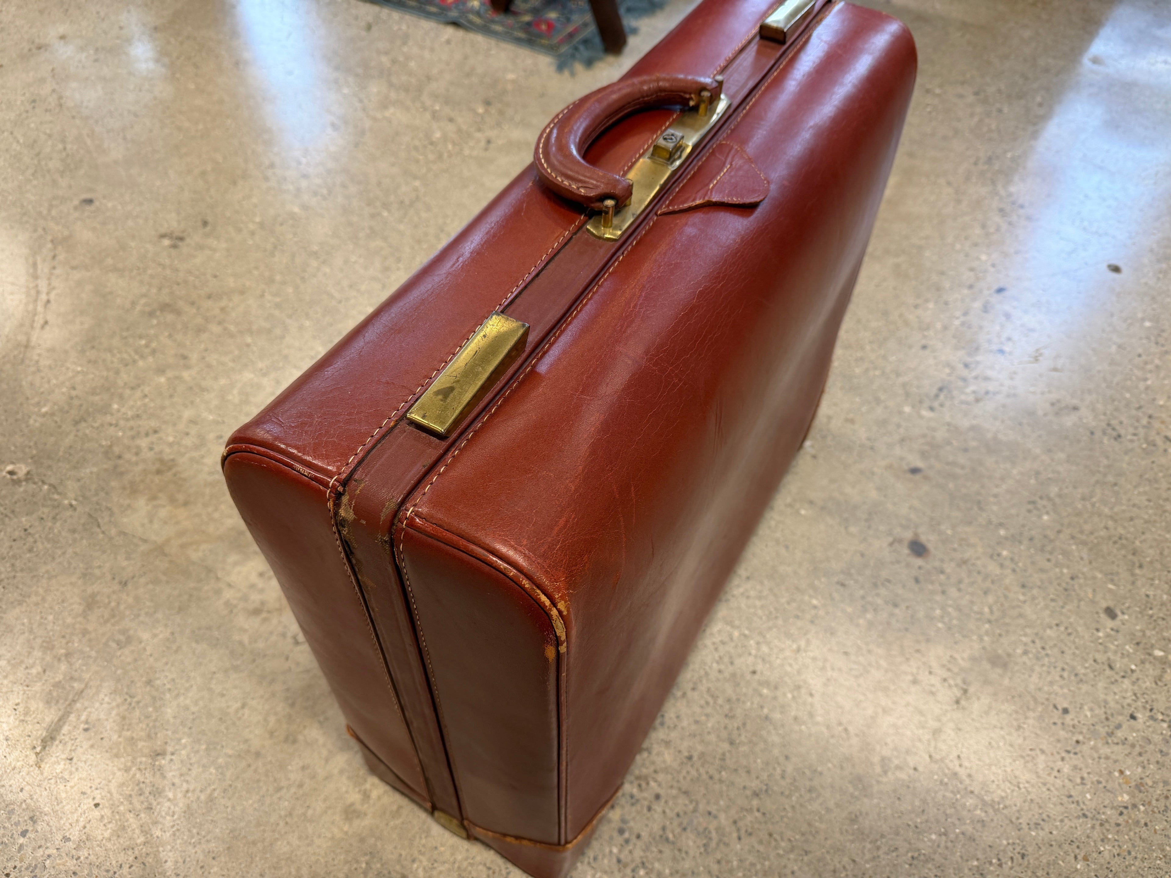 Vintage cognac brown leather attaché briefcase with brass hardware and top handle