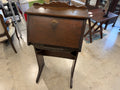 Antique drop-front secretary desk with scalloped gallery, brass ring pull, and carved fan apron
