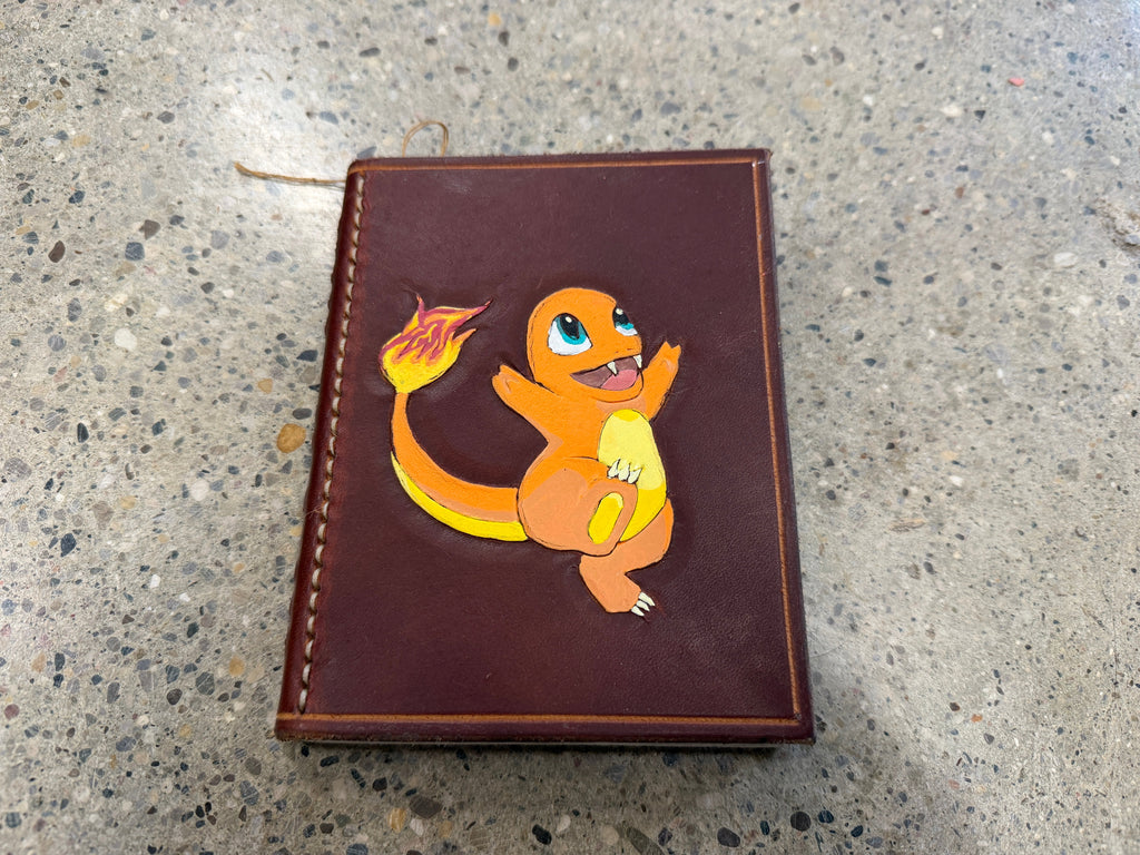 Hand-tooled leather journal with Charmander design on cover