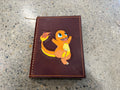 Hand-tooled leather journal with Charmander design on cover