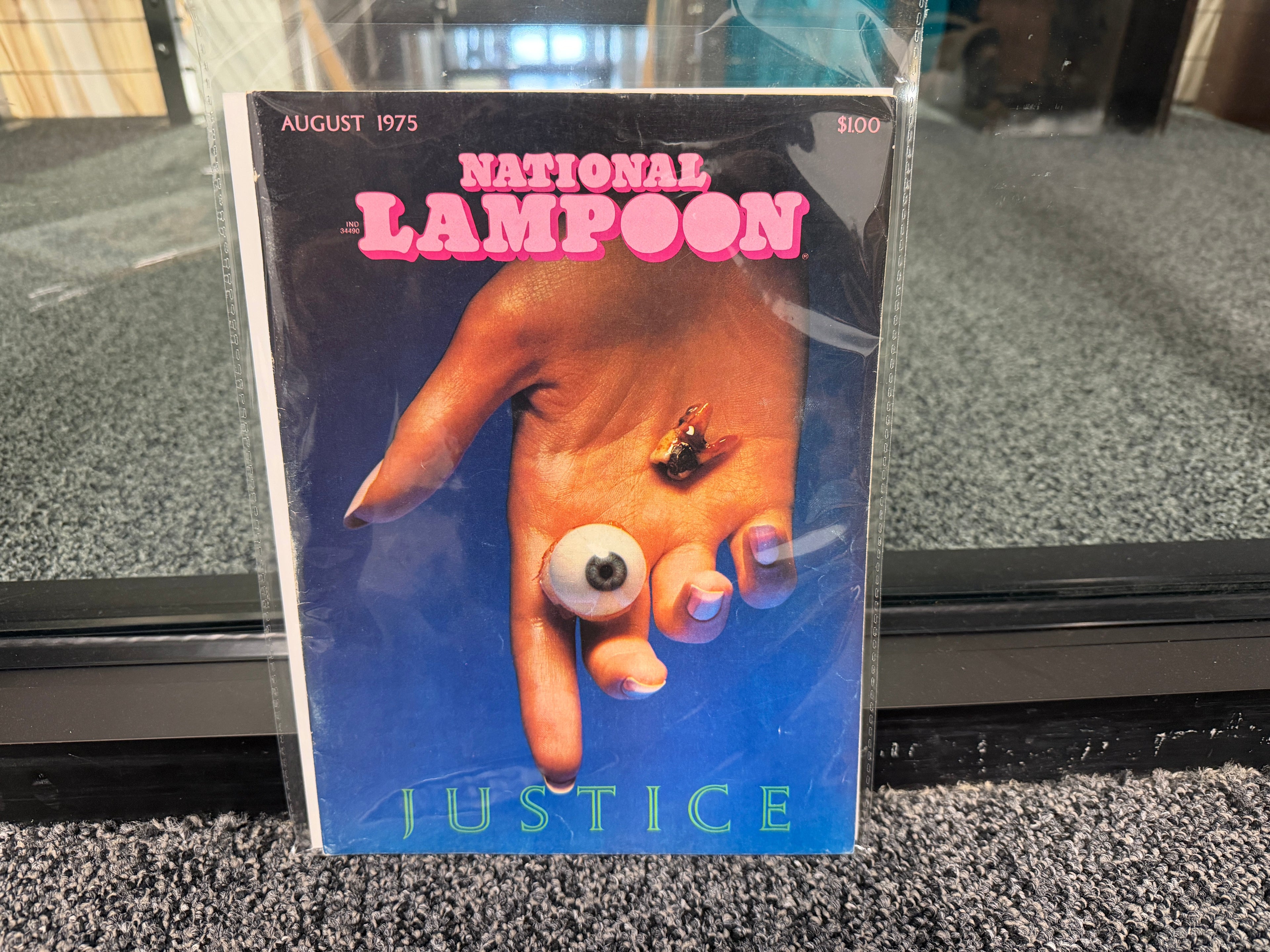 National Lampoon August 1975 Justice issue cover with hand holding eyeball and bee