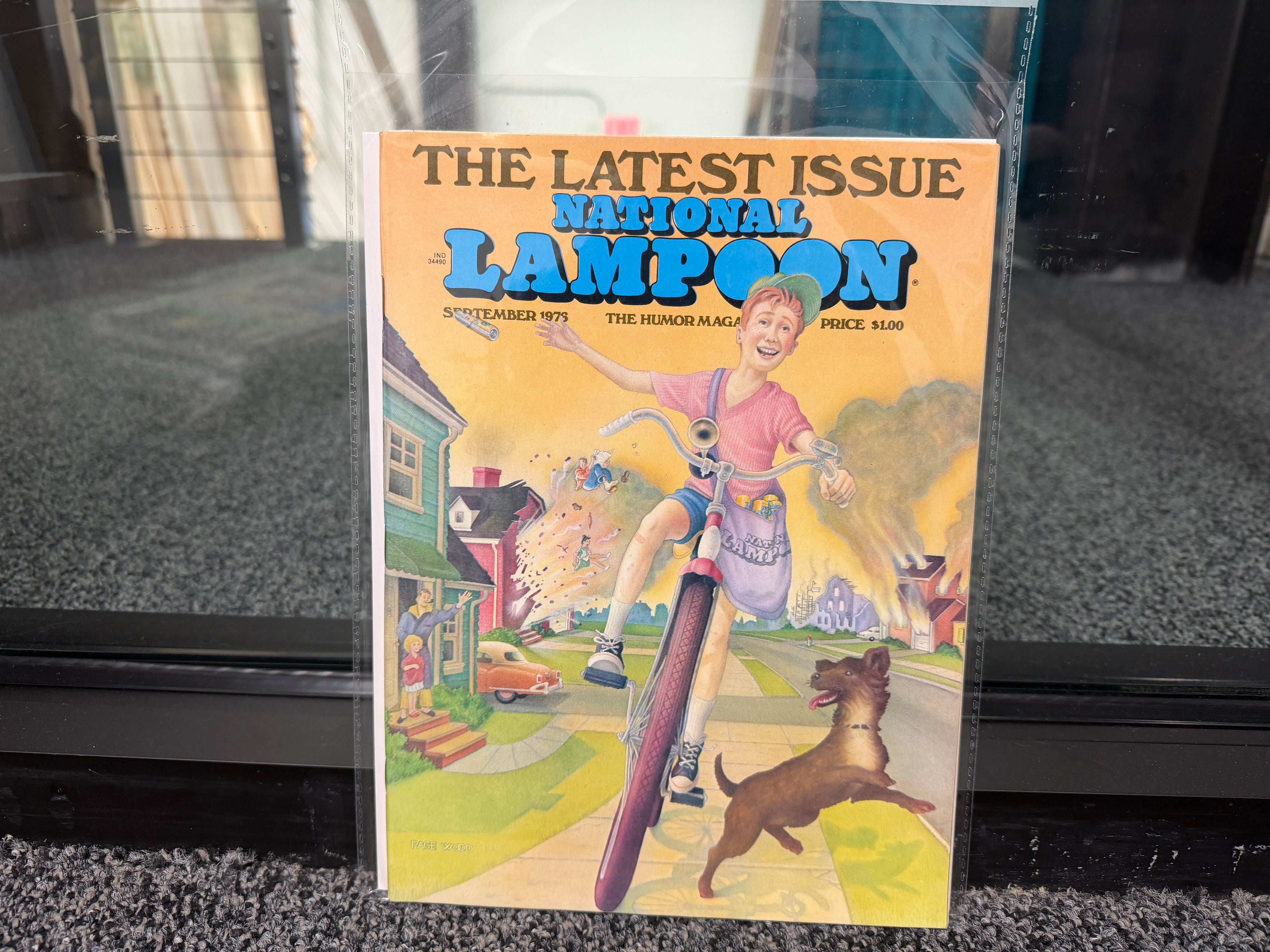 National Lampoon September 1976 The Latest Issue cover with boy on bicycle and suburban chaos