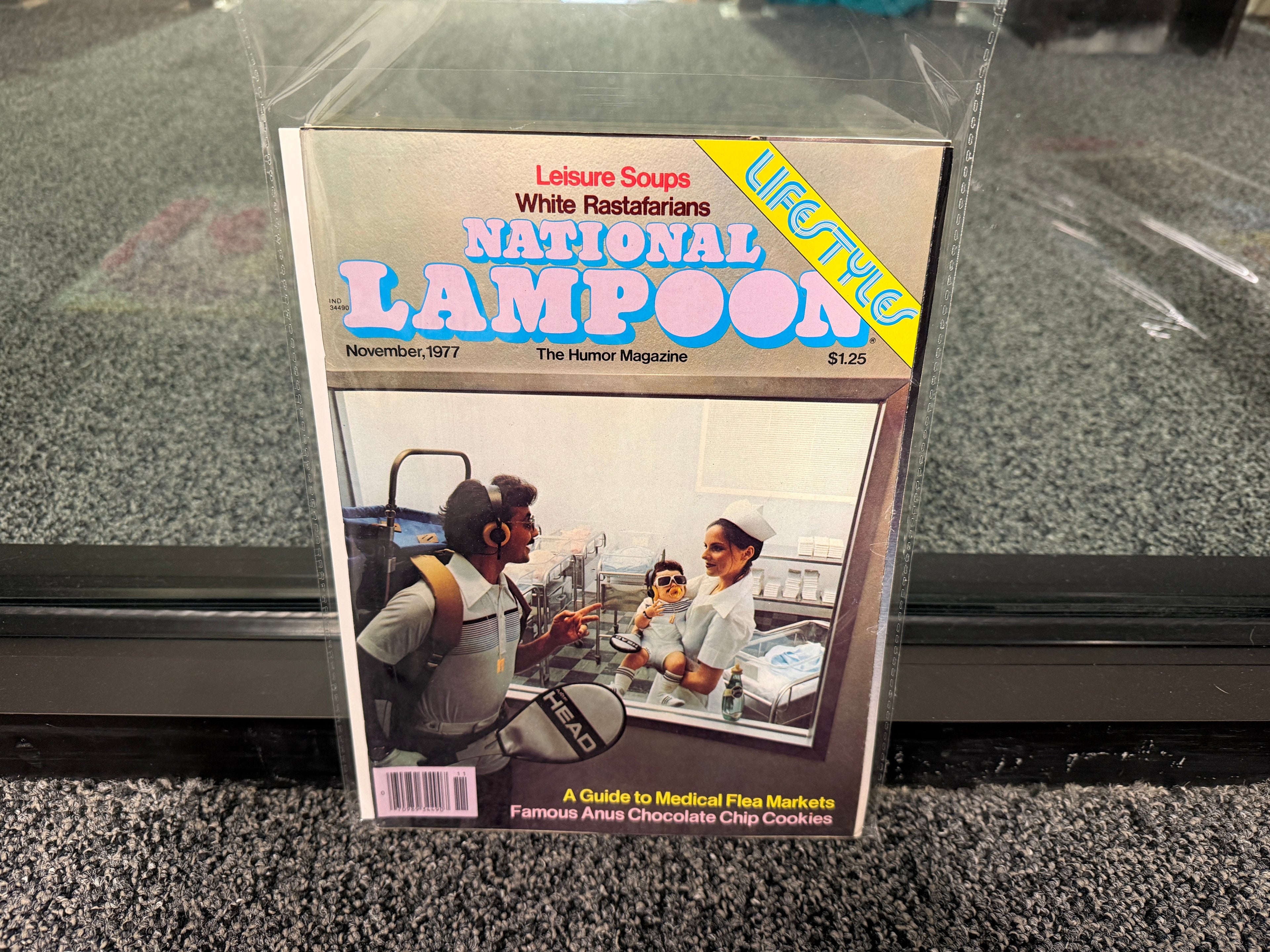 National Lampoon November 1977 Lifestyles issue cover with tennis man and baby in sunglasses
