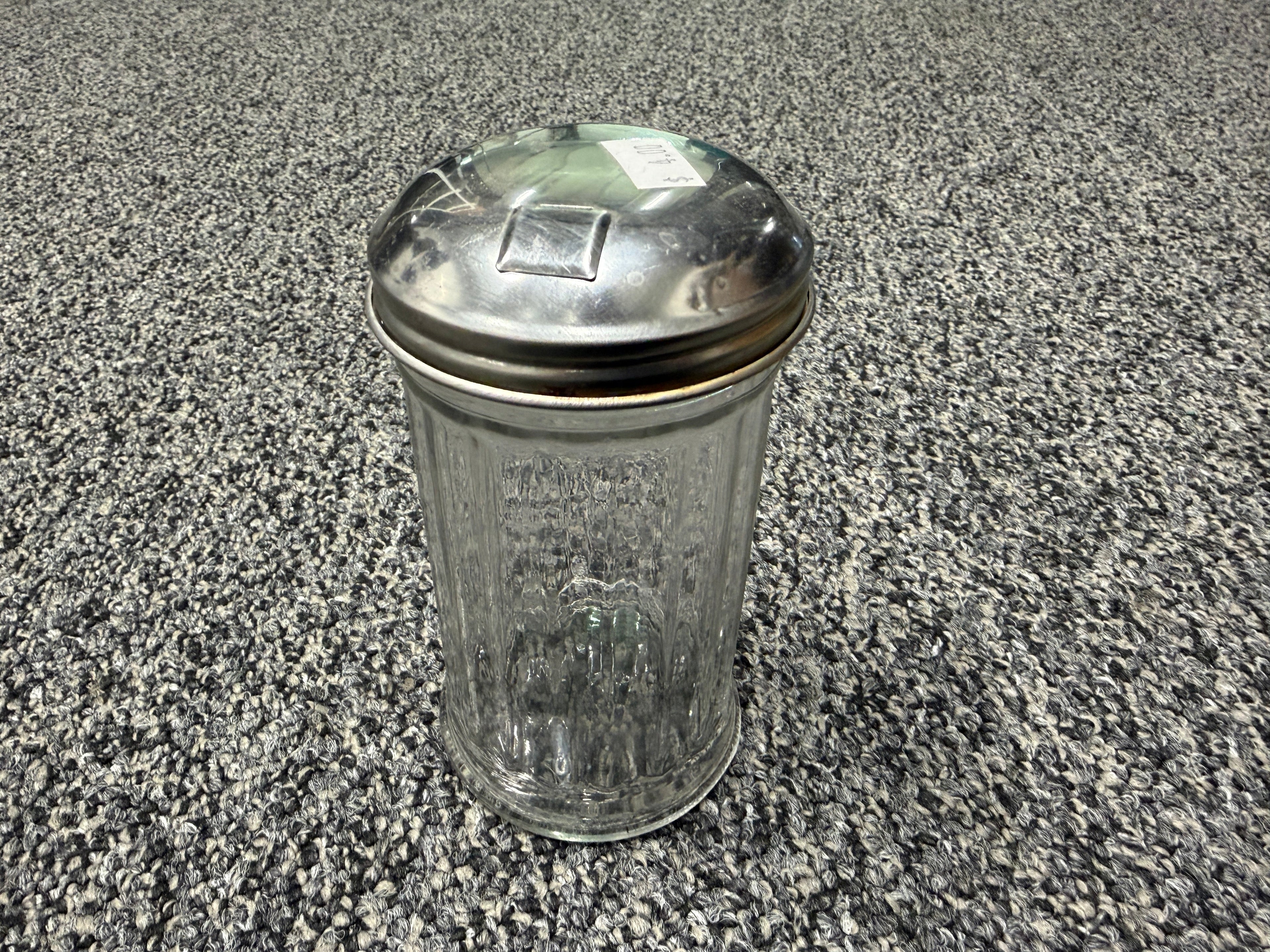 Vintage glass sugar shaker with metal flip-top lid