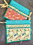 Handmade walker caddy by Sweet Sinister — teal binding with coral floral and bird-print quilted pockets
