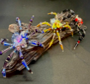 Handmade large display spiders by Sweet Sinister — wire body with colorful glass bead legs in blue, green, pink, and orange