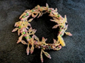 Handmade leaf fringe bracelet by Sweet Sinister — gold-tone wire cuff with cascading leaf and fringe charms