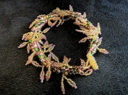Handmade leaf fringe bracelet by Sweet Sinister — gold-tone wire cuff with cascading leaf and fringe charms