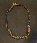 Handmade dark crystal drop charm necklace by Sweet Sinister — dark beads with green crystal drops and star and cross charms