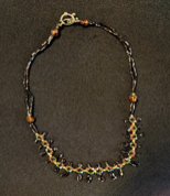 Handmade dark crystal drop charm necklace by Sweet Sinister — dark beads with green crystal drops and star and cross charms